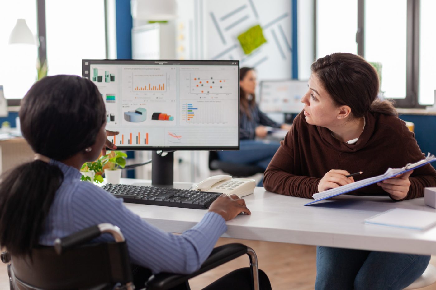 Product team reviewing analytics dashboards together in a modern office